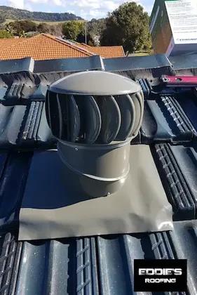 Whirly bird installed on a charcoal tiled roof
